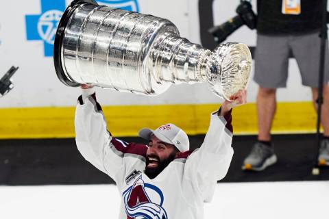 Colorado Avalanche center Nazem Kadri lifts the Stanley Cup after the team defeated the Tampa B ...