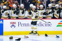 Boston Bruins' David Pastrnak, center, celebrates his third goal with teammates as he skates pa ...