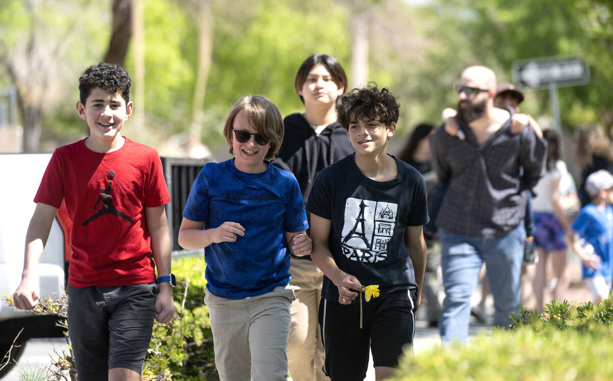 People walk along during the Six Million Steps gathering at The Hills Park on April 16, 2023, i ...