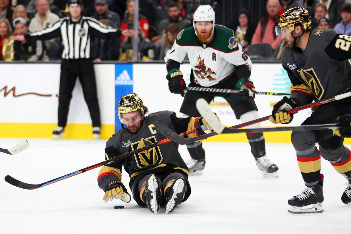 Vegas Golden Knights right wing Mark Stone (61) reaches for a puck after taking a fall during t ...