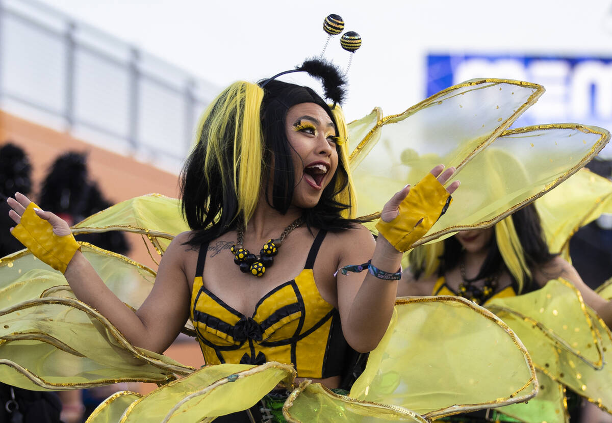 Entertainers walk the festival grounds during day three of Electric Daisy Carnival on Sunday, M ...