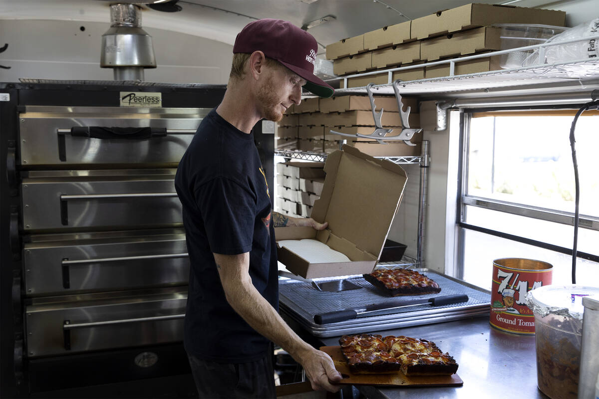 Chef Brett Geiger boxes a Detroit-style pizza at his food truck, Izzy’s Pizza Bus, outside Ve ...