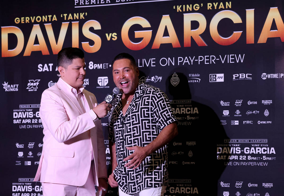 Boxing promoter and former champion Oscar De La Hoya, right, talks to Premier Boxing Champions ...