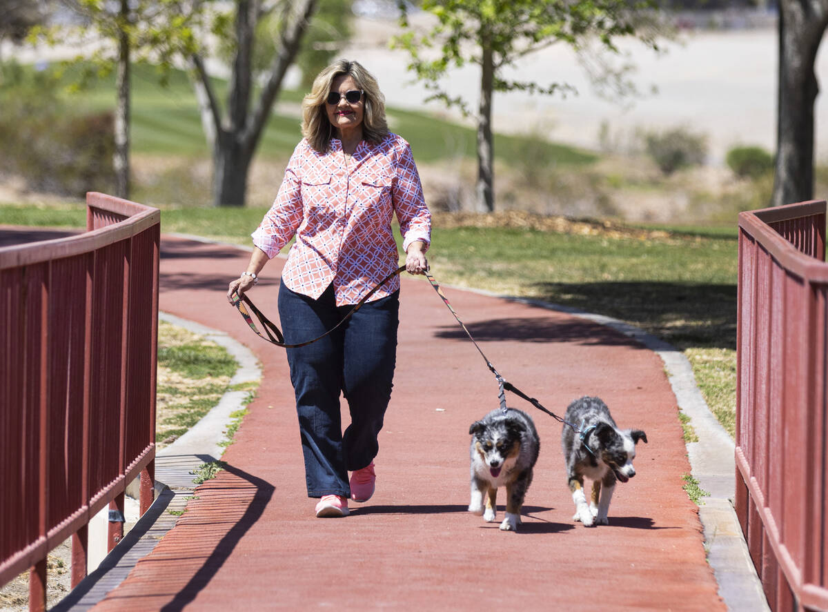 Ellie Thomas, who weighs 315 pounds in 2016, walks her dogs Willow and Caliblue, on Friday, Apr ...