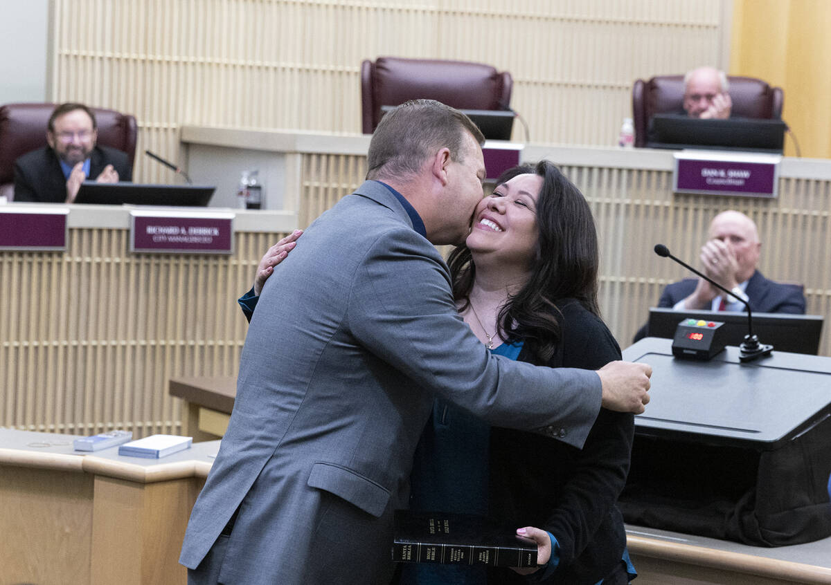 Jim Seebock embraces his wife Barbara after being sworn in as Ward 1 City Councilman at Henders ...