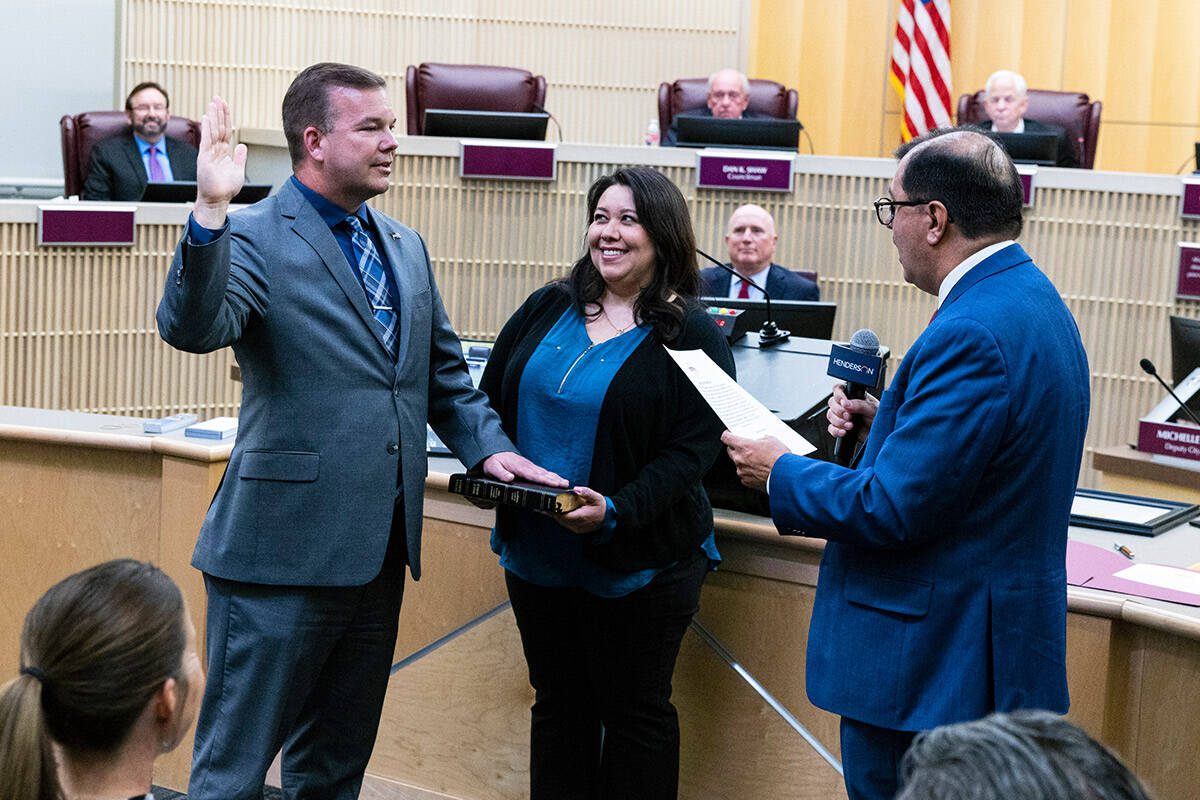 Jim Seebock sworn in as Ward 1 City Councilman by City Clerk Jose Luis Valdez, right, as his wi ...