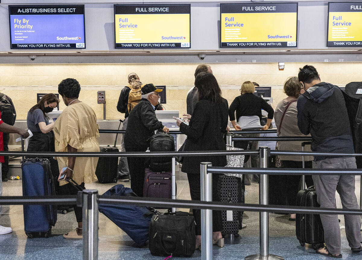 Passengers line up to check in at Southwest check in counter in Terminal 1 of Harry Reid Intern ...