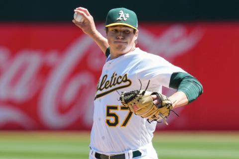 Oakland Athletics pitcher Mason Miller throws against the Chicago Cubs during the first inning ...