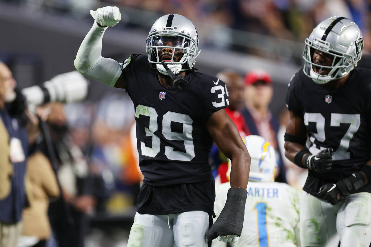 Raiders cornerback Nate Hobbs (39) with cornerback Sam Webb (27), reacts after defending a pass ...