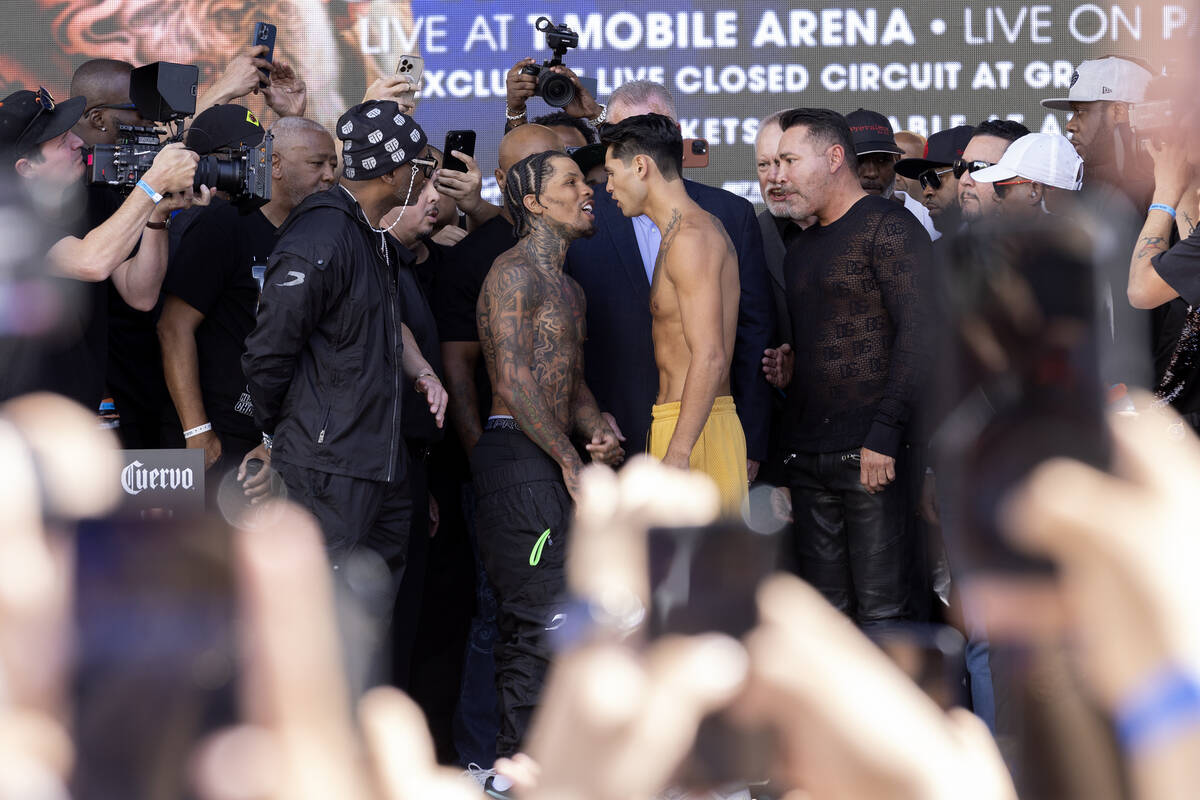 Gervonta Davis, center left, faces Ryan Garcia during their weigh-in at Toshiba Plaza on Friday ...