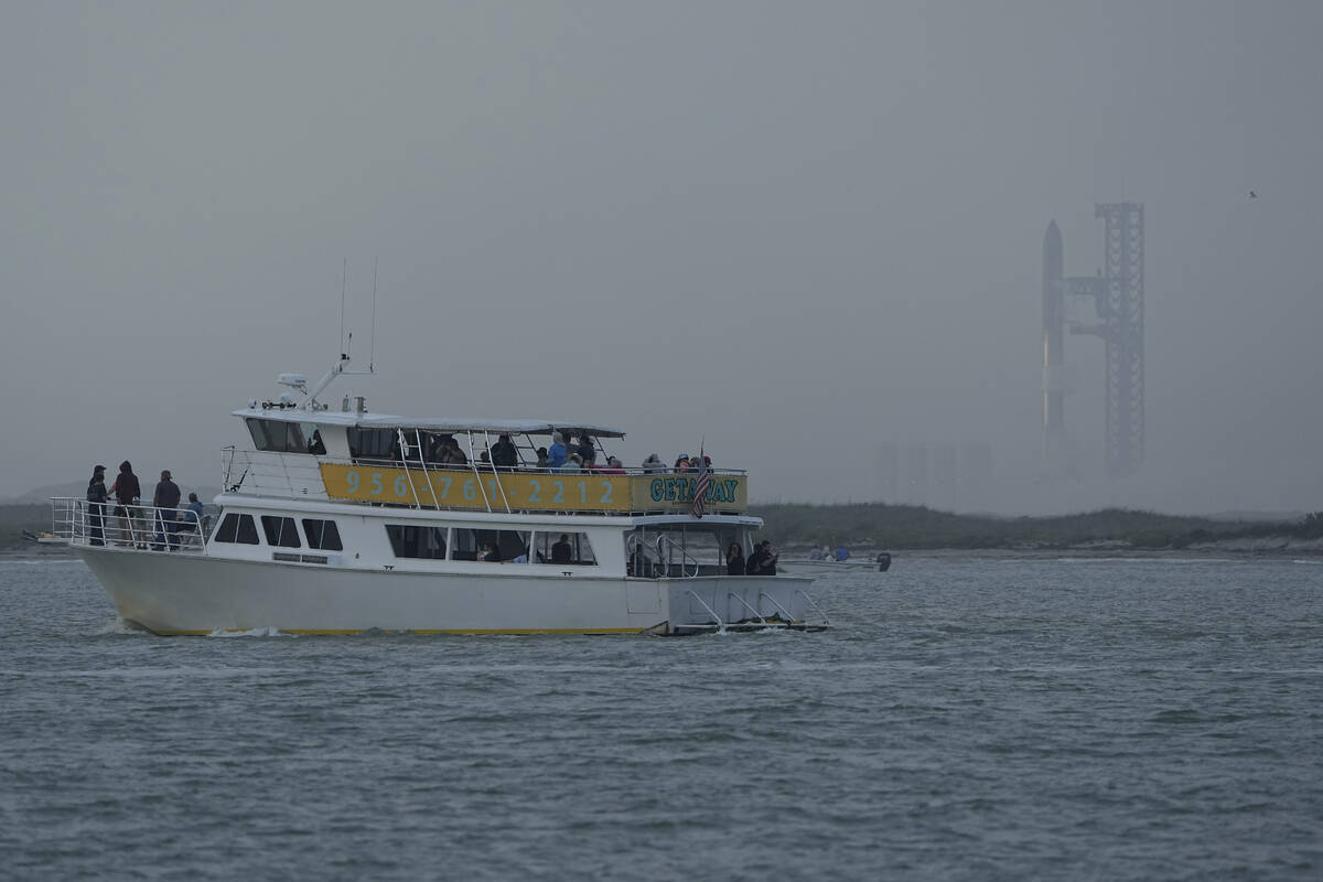A tour boat passes SpaceX's Starship, the world's biggest and most powerful rocket, was it prep ...