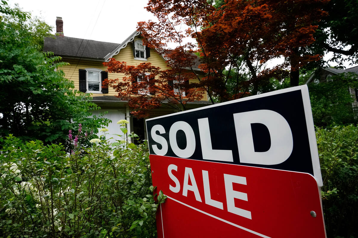 FILE - A sale sign stands outside a home in Wyndmoor, Pa., Wednesday, June 22, 2022. On Friday, ...