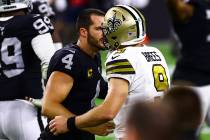 Las Vegas Raiders quarterback Derek Carr (4) greets New Orleans Saints quarterback Drew Brees ( ...