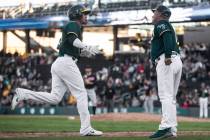 Oakland Athletics Edwin Diaz, left, rounds third base after hitting a home run in the 8th innin ...