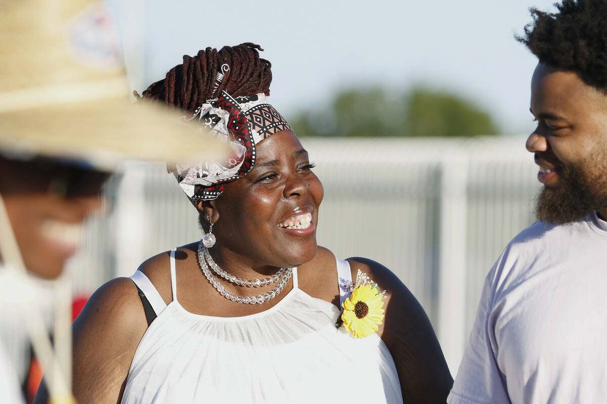Tameka Henry, center, executive director of Obodo Collective, socializes with Christian Jones a ...
