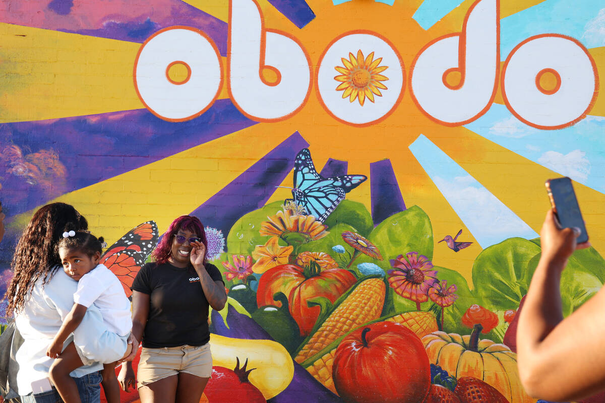 Cheyenne Kyle, food programs coordinator for Obodo Colective, left center, wipes her eye shortl ...