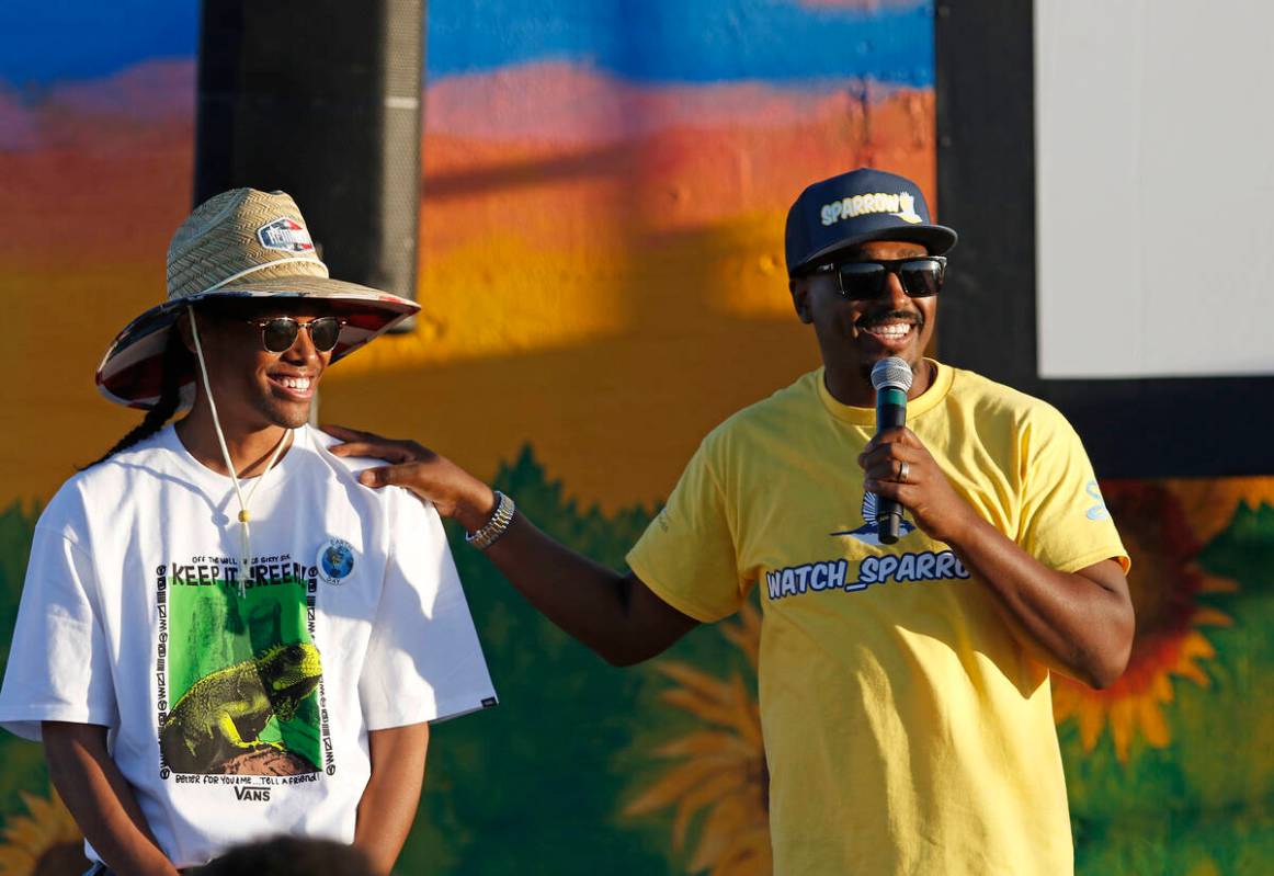 Mural artists Malachi Williams, right, and Dyron Boyd stand before a crowd at the unveiling of ...