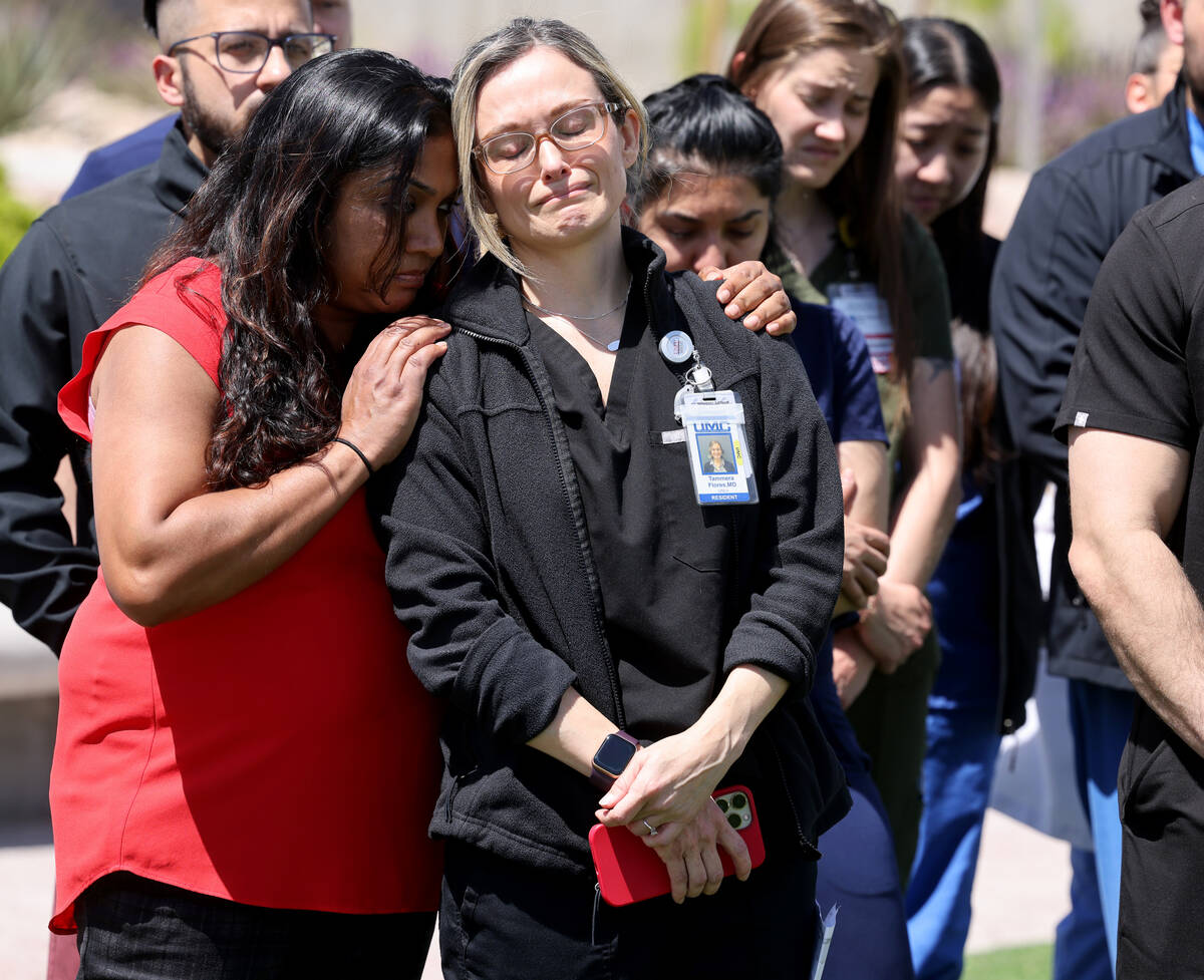 Dr. Tammera Flores, right, a colleague of slain Dr. Gwen Amsrala, gets a hug from Internal Medi ...