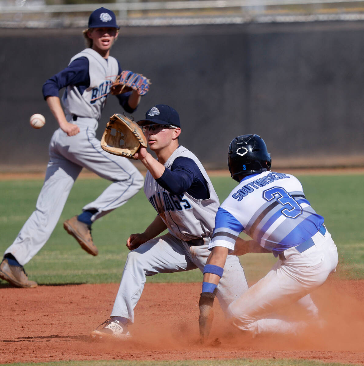 Basic's Ty Southisene (3) steals second before Centennial's Noa Oyadomari (5) catches the ball ...