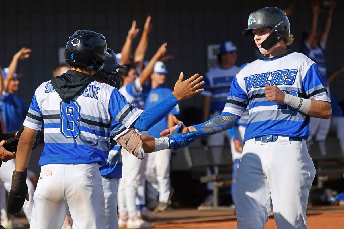 Basic's Tate Southisene (8) and Basic’s Cooper Sheff (22), right, high-five after they both s ...