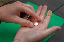FILE - A patient prepares to take the first of two combination pills, mifepristone, for a medic ...