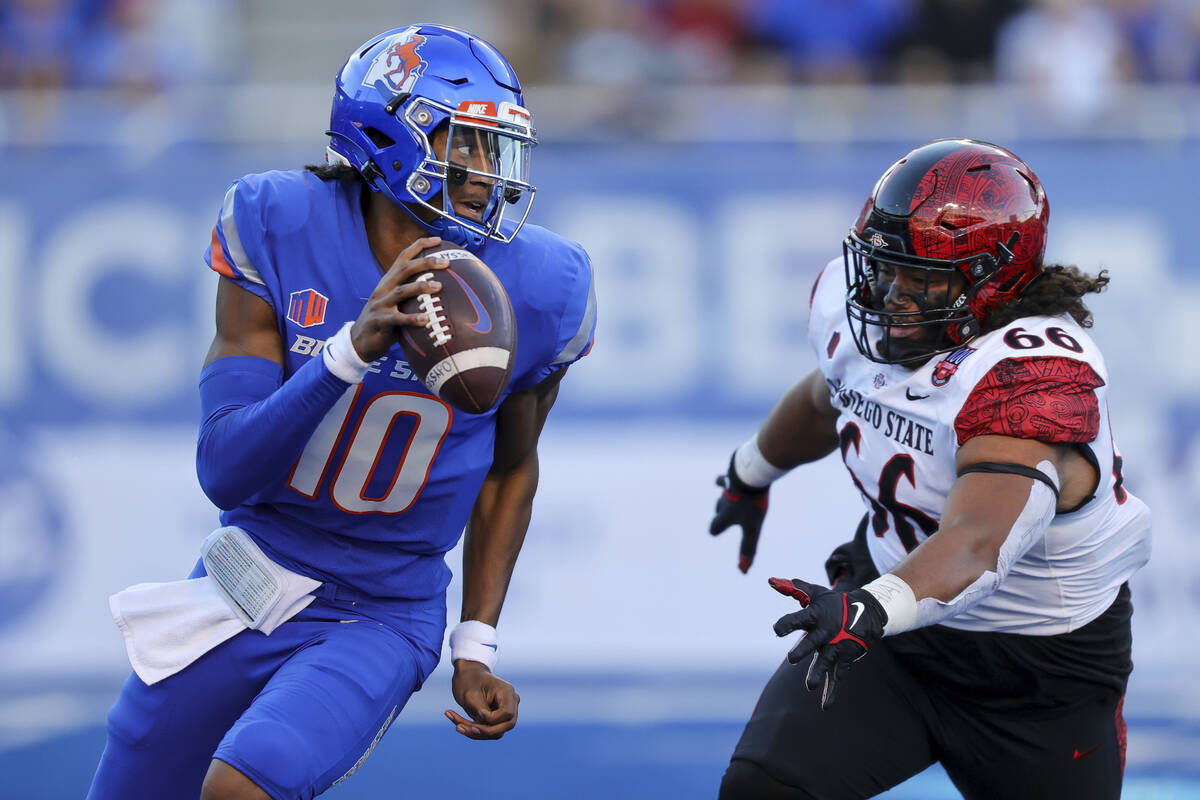 Boise State quarterback Taylen Green (10) is chased out of the pocket by San Diego State defens ...