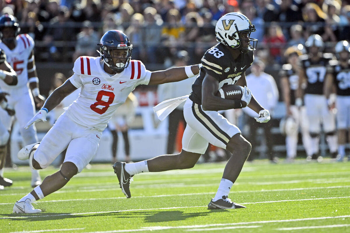 Vanderbilt wide receiver Gamarion Carter (83) runs as Mississippi linebacker Troy Brown (8) def ...