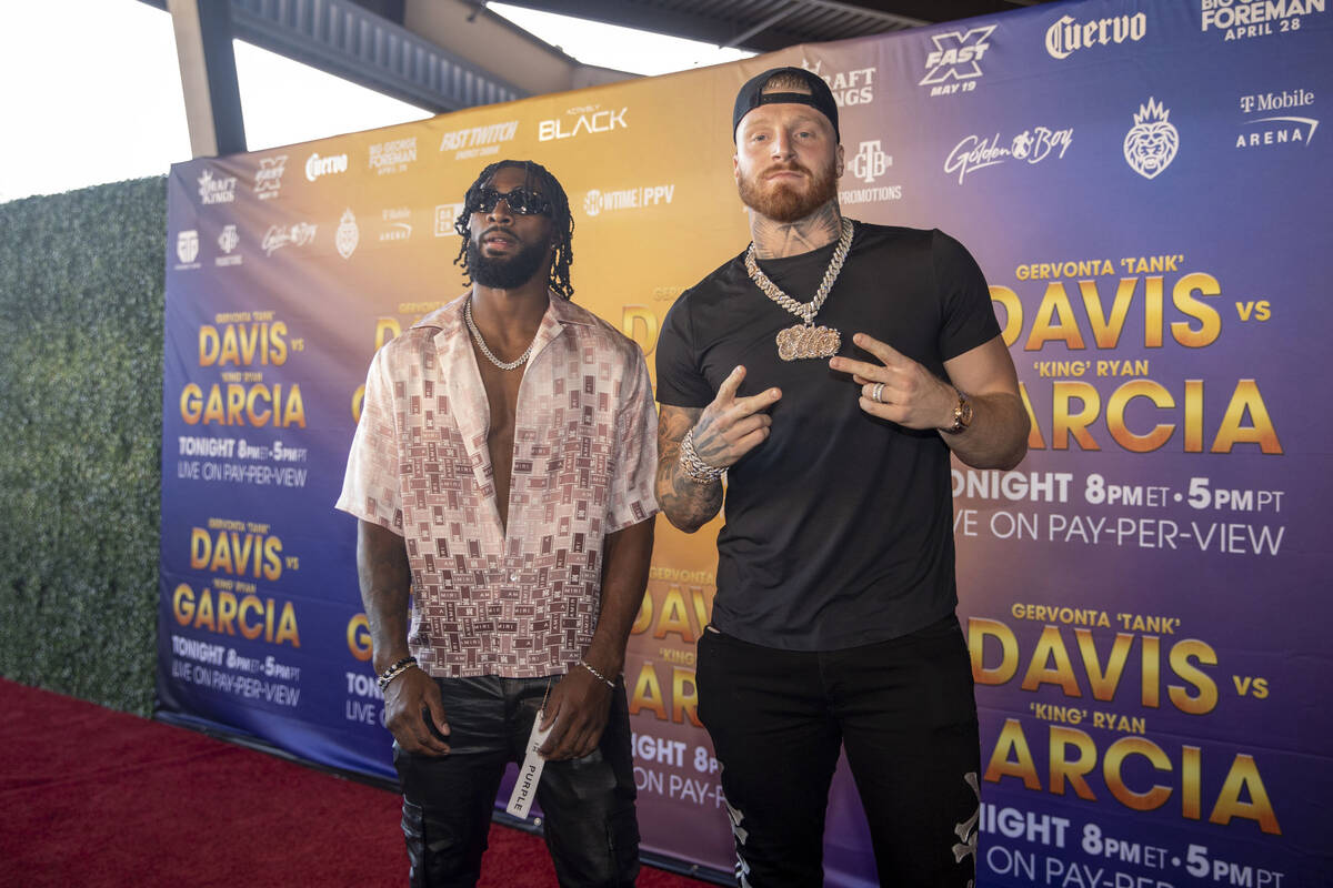 Raiders cornerback Nate Hobbs, left, poses with defensive end Maxx Crosby on the red carpet pri ...