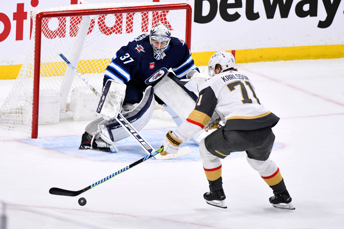 Vegas Golden Knights' William Karlsson (71) gets ready to take a shot on Winnipeg Jets goaltend ...