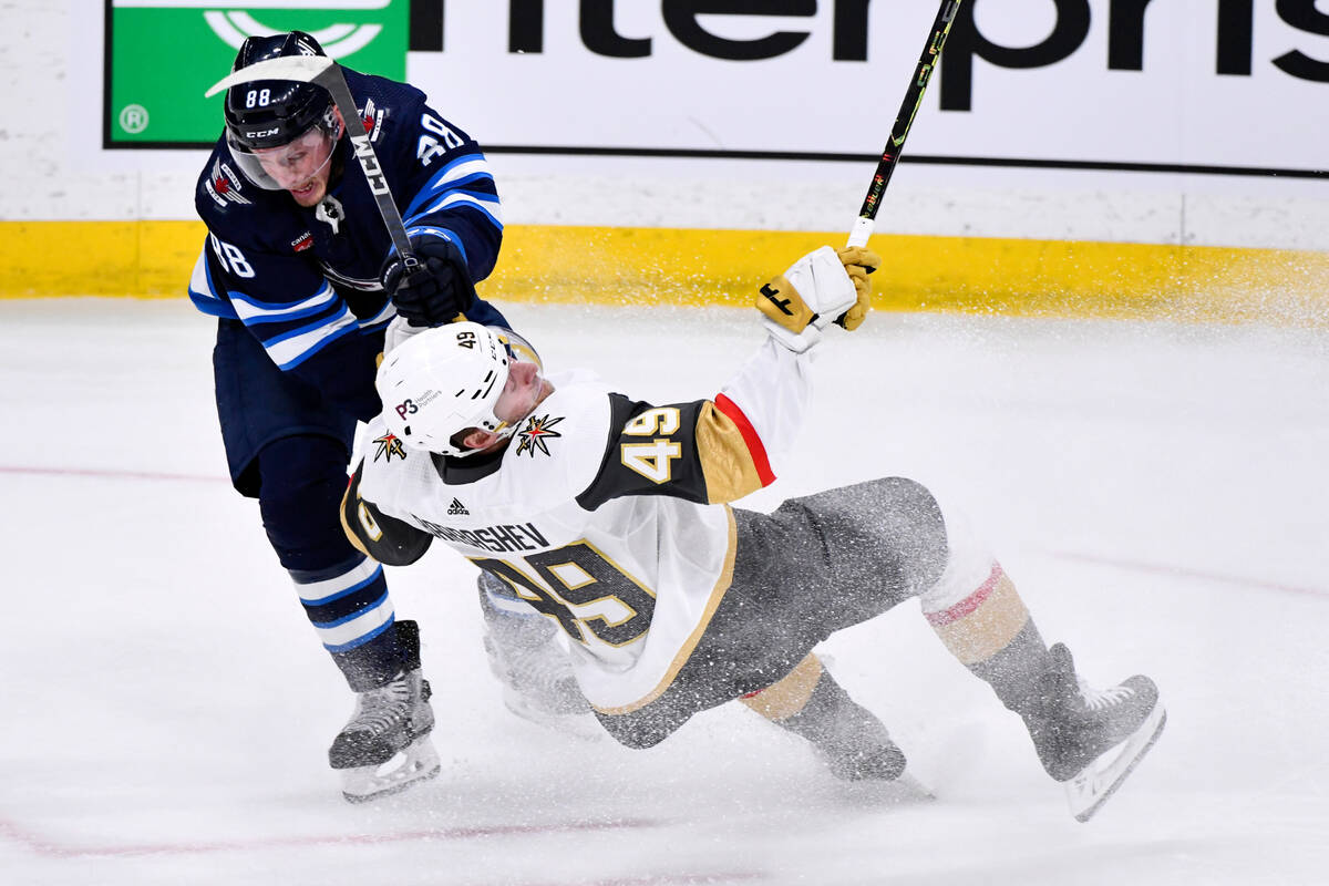 Winnipeg Jets' Nate Schmidt (88) checks Vegas Golden Knights' Ivan Barbashev (49) during first- ...