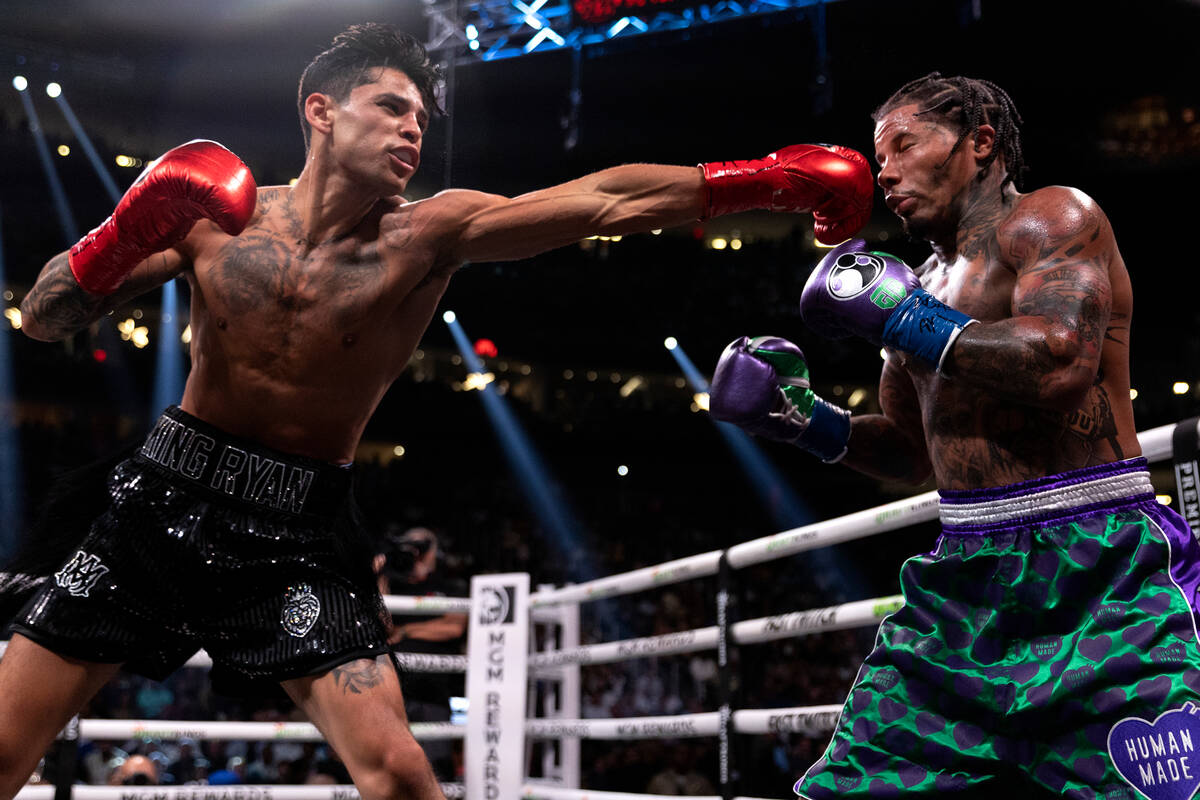 Ryan Garcia hits Gervonta Davis during a catchweight boxing bout at T-Mobile Arena on Saturday, ...