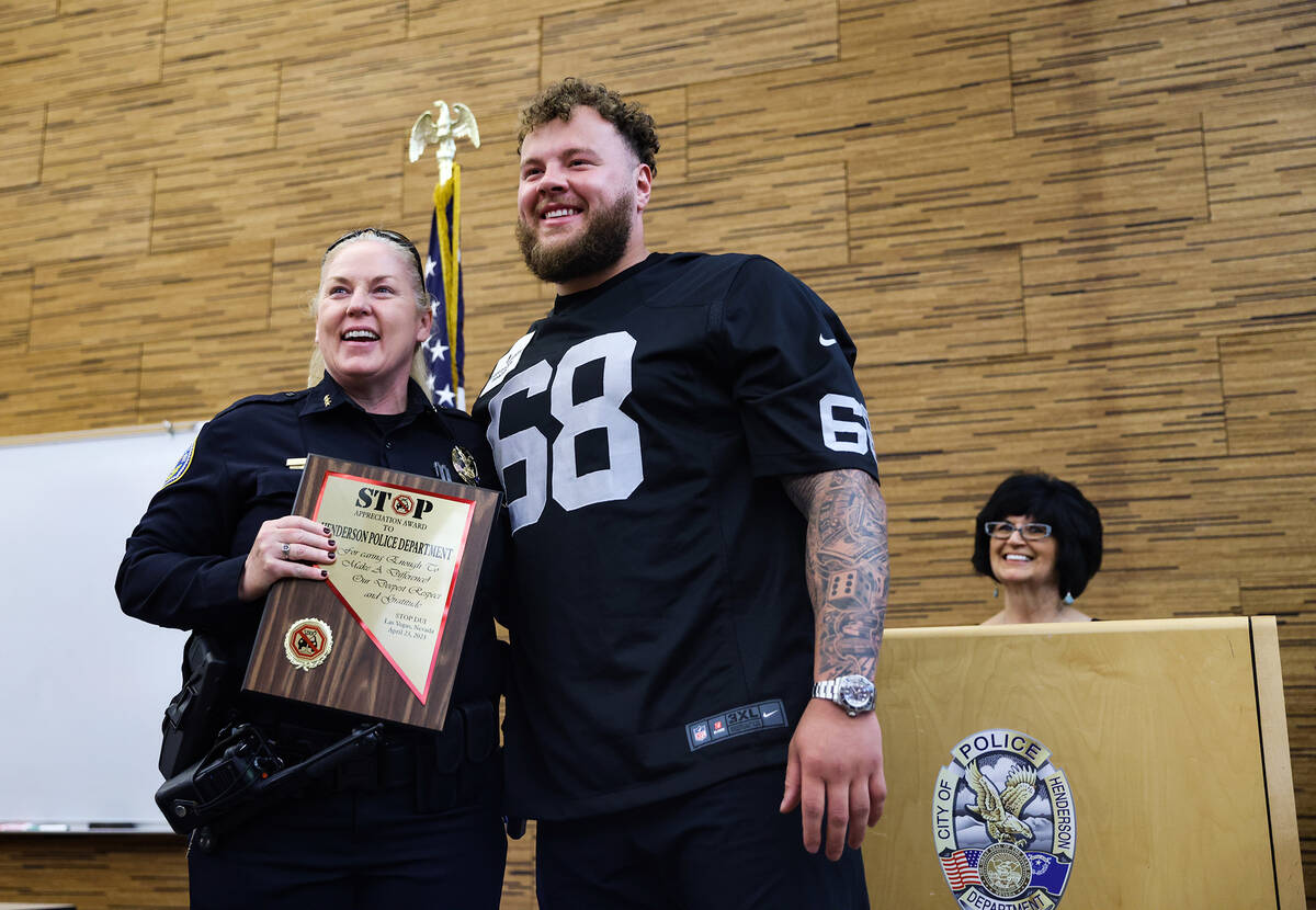 Henderson Police Chief Hollie Chadwick, left, poses for a photo with Raiders offensive lineman ...