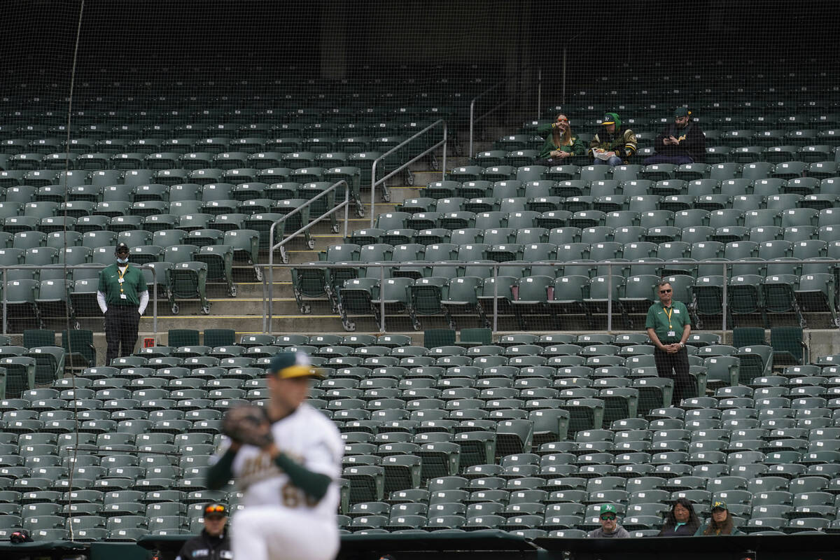 Fans and stadium workers watch as Oakland Athletics' Daulton Jefferies pitches against the Balt ...