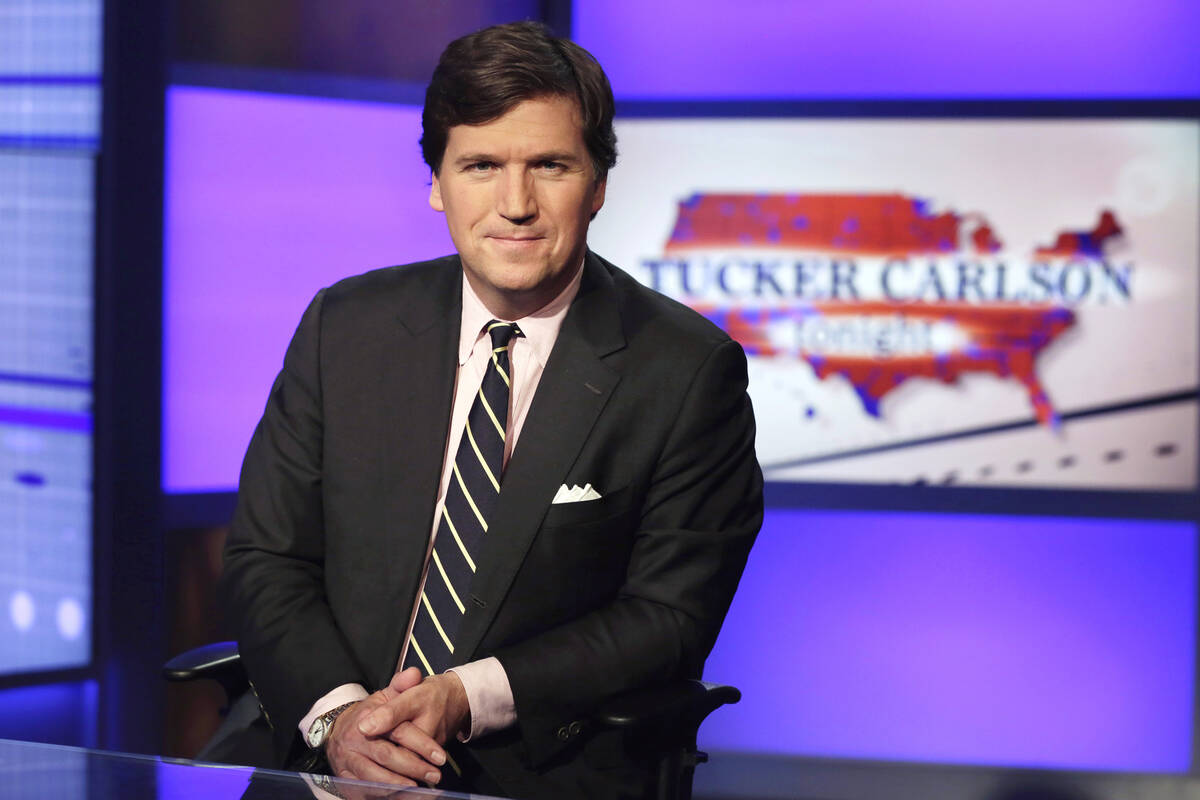 FILE - Tucker Carlson, host of "Tucker Carlson Tonight," poses for photos in a Fox Ne ...