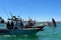 An upright 43-foot Outerlimits boat is seen sticking out of the water of Lake Havasu after it c ...