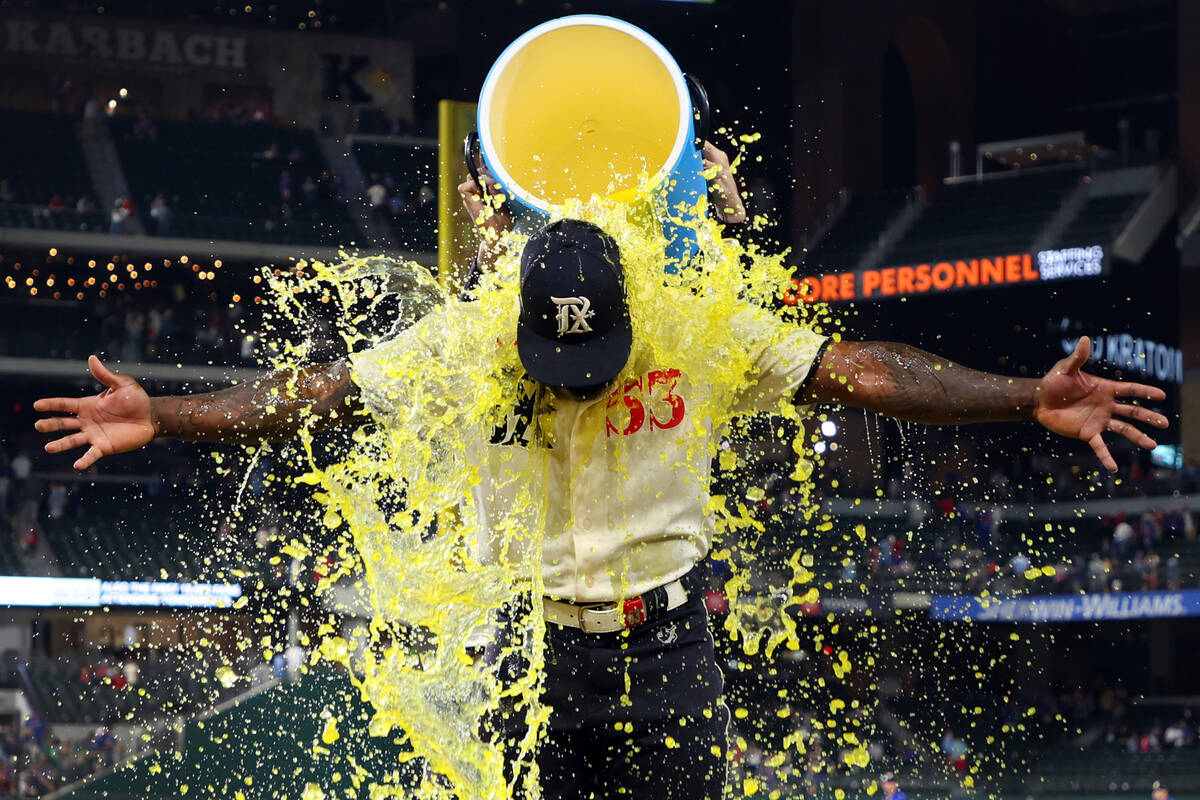 Texas Rangers' Adolis Garcia (53) gets doused with a sports drink after a game against the Oakl ...