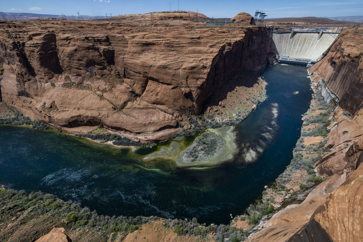 The Colorado River flows below the Glen Canyon Dam on Tuesday, April 18, 2023, in Page, AZ. (L. ...