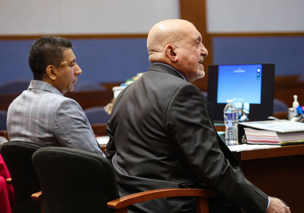 Adolfo Orozco, former owner of the Alpine Apartments, left, listens as his attorney Dominic Gen ...