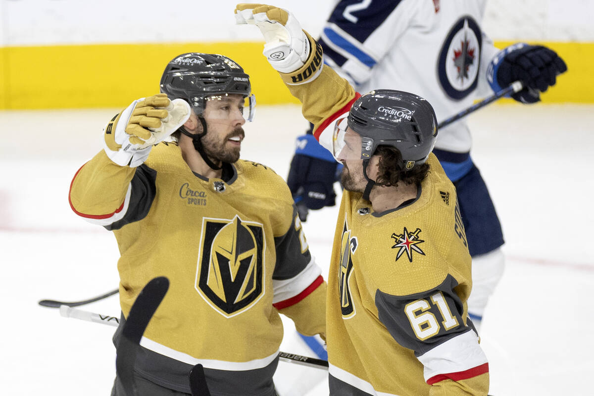 Golden Knights right wing Mark Stone (61) congratulates center Chandler Stephenson (20) on his ...