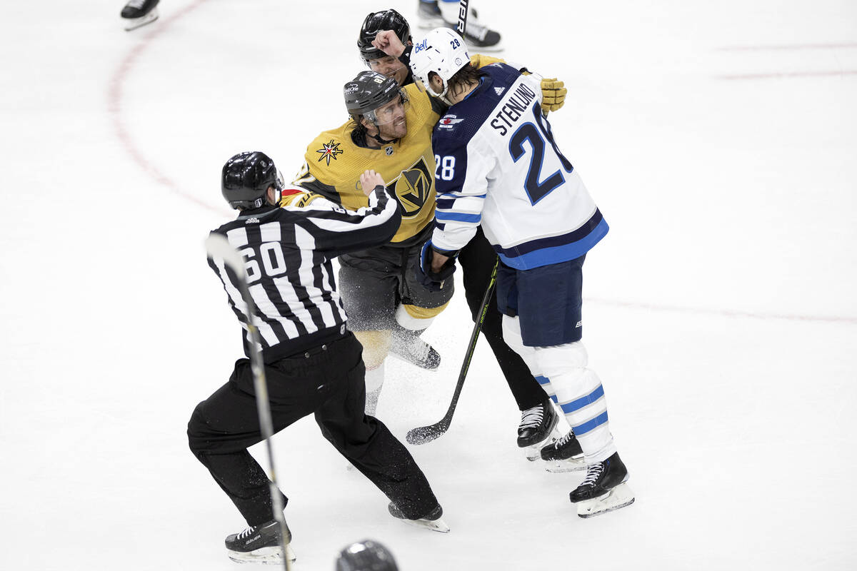 Referees break up a fight between Golden Knights right wing Jonathan Marchessault (81) and Winn ...