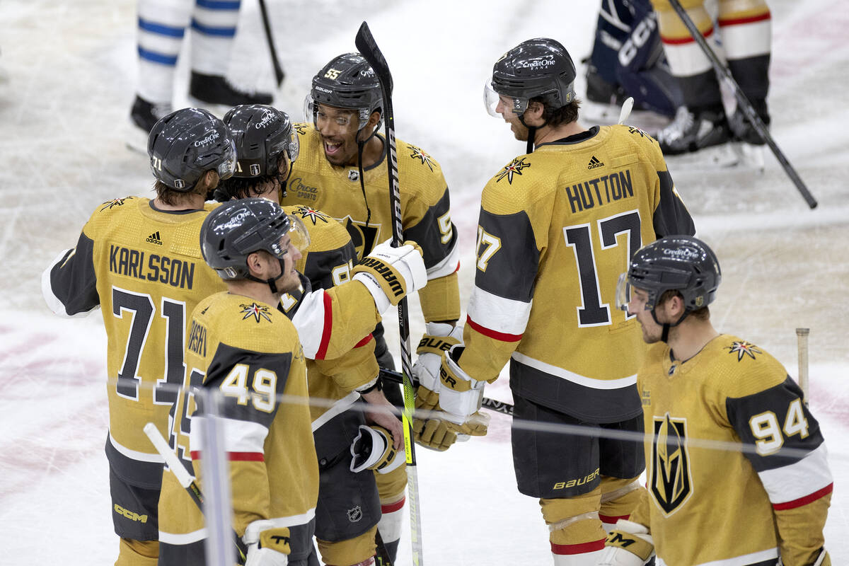 Golden Knights players gather to celebrate after winning Game 5 of an NHL hockey Stanley Cup fi ...