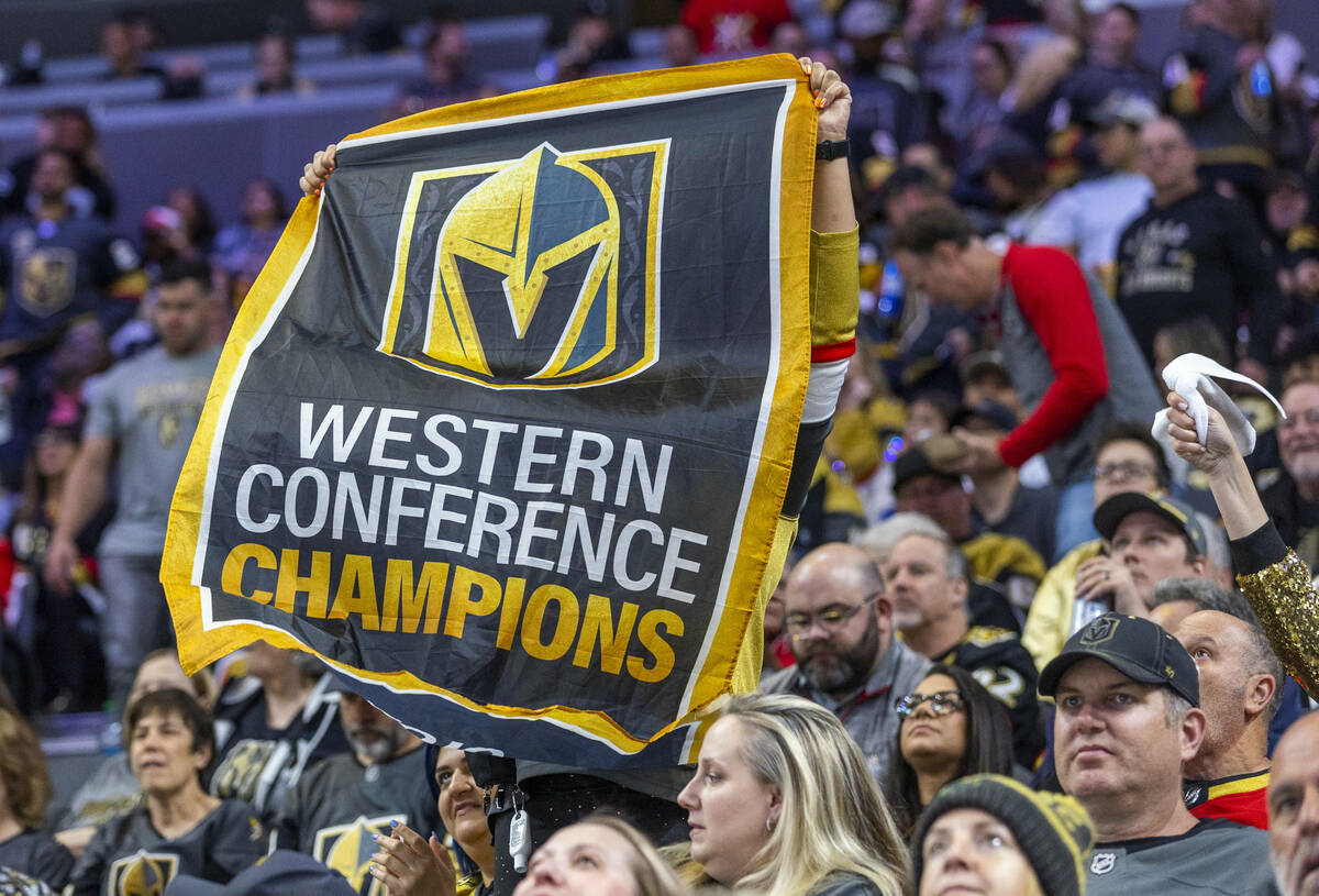 A fan holds up a Western Conference Champions banner as the Golden Knights battle the Winnipeg ...