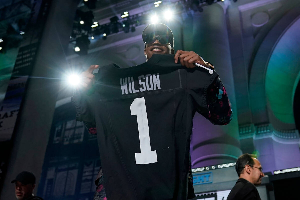 Texas Tech defensive lineman Tyree Wilson stands on stage after being chosen by the Las Vegas R ...