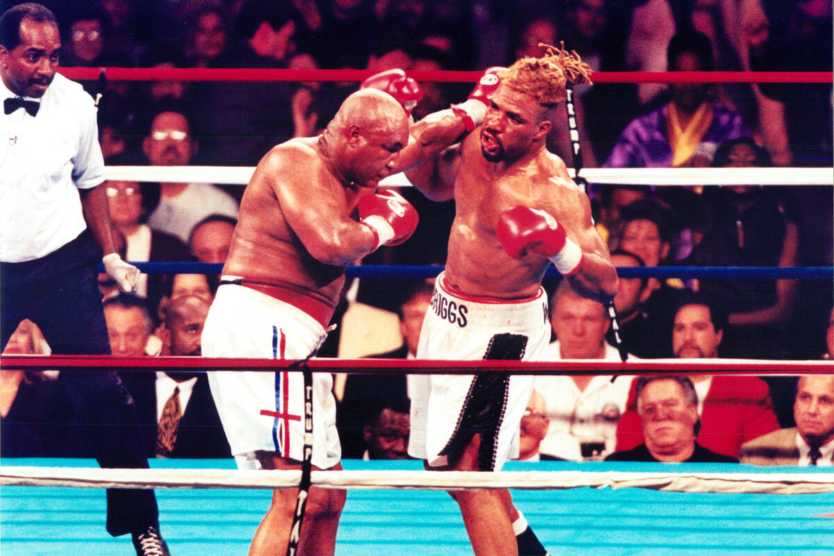 George Foreman, left, trades punches with Shannon Briggs in their Nov. 22, 1997, heayweight box ...