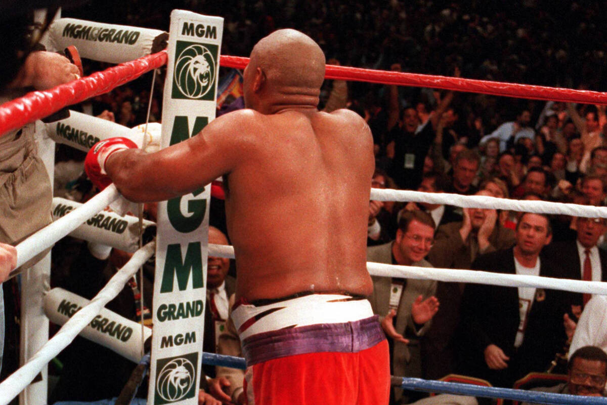George Foreman kneels and prays after stopping Michael Moorer in the 10th round on Nov. 5, 1994 ...