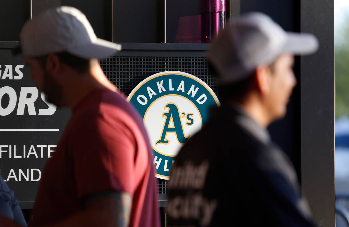 People walk by a seal for the Oakland A’s at the entrance to Las Vegas Ballpark Tuesday, ...