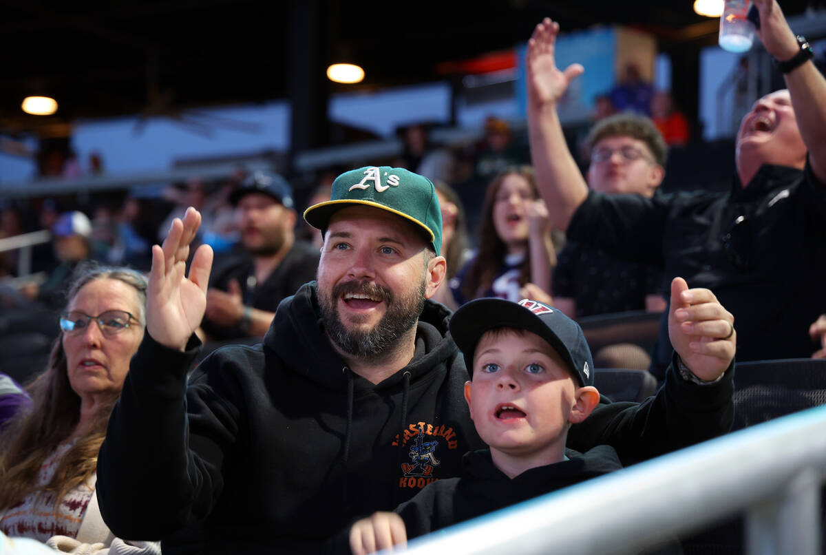 Buford Kenton, left, cheers with son Charleston, 9, during an Aviators game against the Tacoma ...