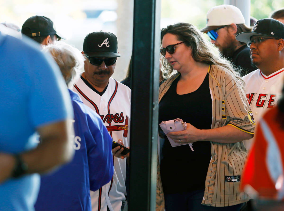 Noe Vasquez, left, and wife Jeannie scan their tickets to enter Las Vegas Ballpark before the s ...