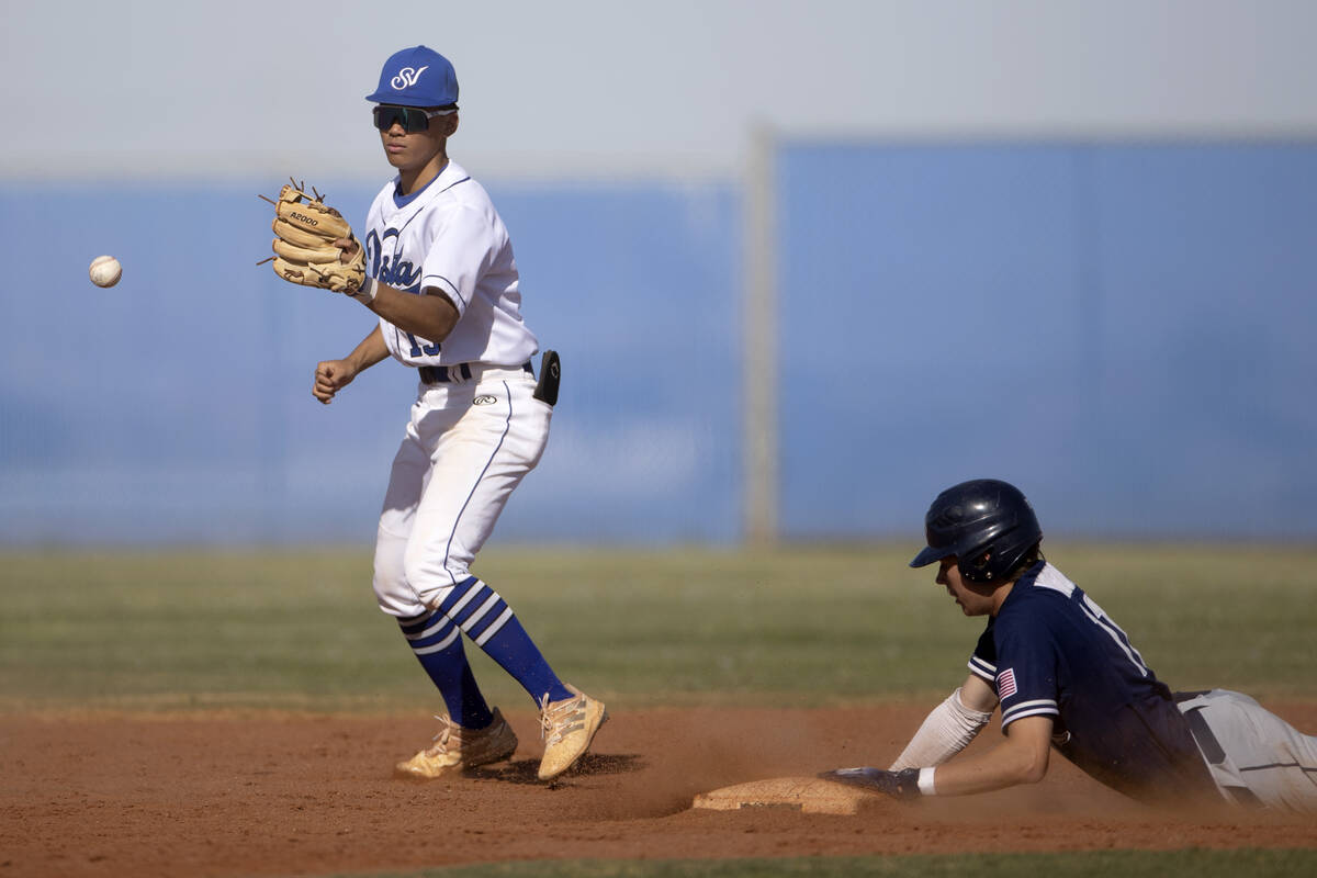 Sierra Vista’s Ethan Villa reaches to catch while Shadow Ridge’s Brock Morrow sli ...