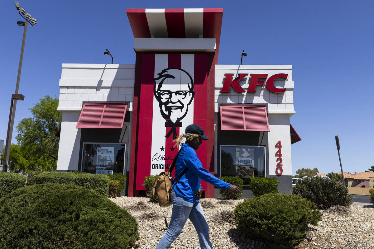A pedestrian walks past a KFC fast-food restaurant, on Wednesday, April 26, 2023, in Las Vegas ...